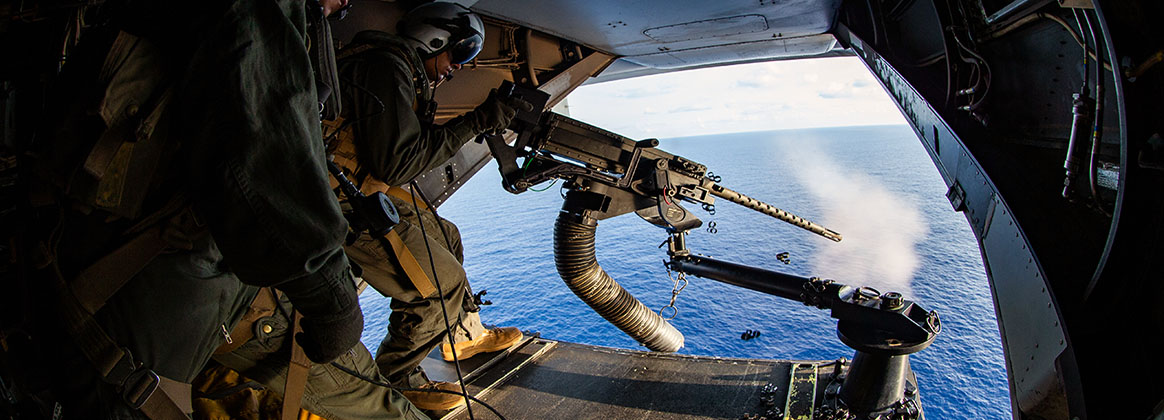 SOUTH CHINA SEA (March 14, 2020) A Marine with Marine Medium Tiltrotor Squadron (VMM) 265 (Reinforced), 31st Marine Expeditionary Unit (MEU), fires an M2 Browning .50 Caliber machine gun off of a CH-53E Super Stallion helicopter with VMM-265 (Rein.), 31st MEU, after departing amphibious assault ship USS America (LHA 6). America, flagship of the America Expeditionary Strike Group, 31st MEU team, is operating in the U.S. 7th Fleet area of operations to enhance interoperability with allies and partners and serve as a ready response force to defend peace and stability in the Indo-Pacific region. 