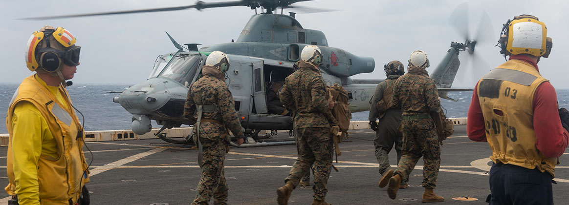 SOUTH CHINA SEA (March 16, 2020) – 31st Marine Expeditionary Unit Marines embarked aboard San Antonio-class amphibious transport dock ship USS Green Bay (LPD 20) prepare to board a UH-1Y Huey helicopter during flight operations. Green Bay, part of the America Expeditionary Strike Group, 31st Marine Expeditionary Unit team, is operating in the U.S. 7th Fleet area of operations to enhance interoperability with allies and partners and serve as a ready response force to defend peace and stability in the Indo-Pacific region.