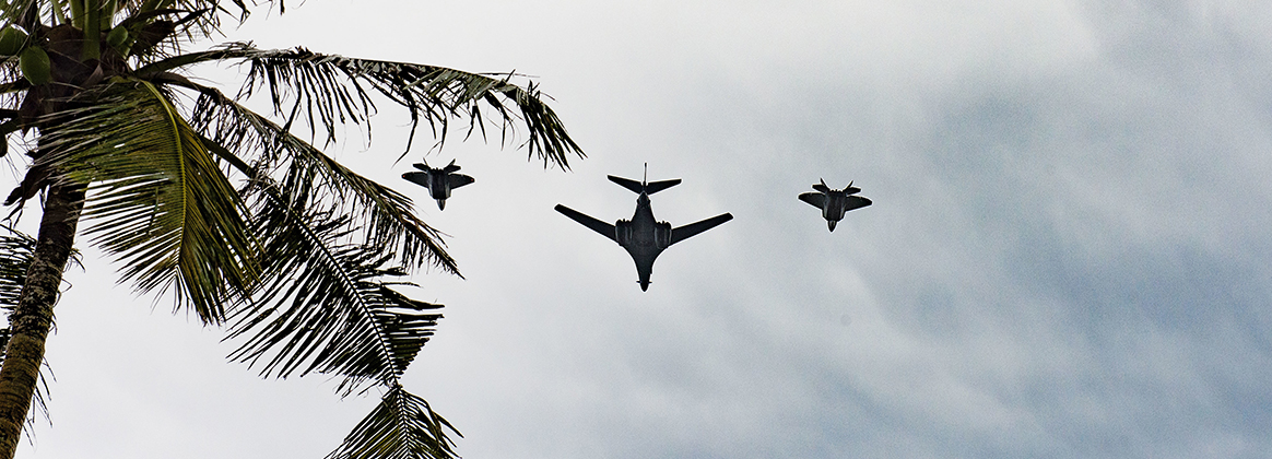 201111-N-KG760-0002 ASAN, Guam (Nov. 11, 2020) A B-1 Lancer, center, and two F-22 Raptors fly in formation to commemorate Veterans Day at Asan Beach Park, Guam, Nov. 11, 2020. The B-1 Lancer is based out of the 9th Bomb Squadron at Dyess Air Force Base, Texas, and the F-22 Raptors are based out of the 94th Fighter Squadron at Joint Base Langley-Eustis, Virginia.