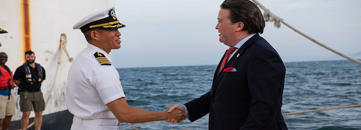 VUNG RO BAY, Vietnam (July 3rd, 2022) – Mr. Marc Knapper, U.S. Ambassador to Vietnam, right, shakes hands with Captain Hank Kim, Pacific Partnership 2022 (PP22) mission commander, upon arrival aboard Military Sealift Command hospital ship USNS Mercy (T-AH 19) during the PP22 Vietnam closing ceremony. Now in its 17th year, Pacific Partnership is the largest annual multinational humanitarian assistance and disaster relief preparedness mission conducted in the Indo-Pacific.