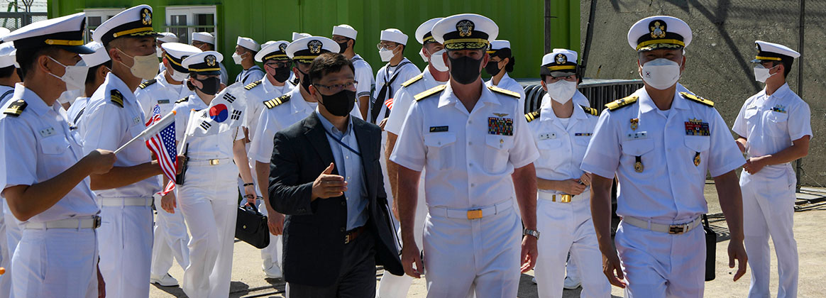 BUSAN, Republic of Korea (Sept. 23, 2022) - Rear Adm. Buzz Donnelly, Commander, Carrier Strike Group (CSG) 5, center, and Rear Adm. Kyung Cheol Kim, Director, Maritime Operations Center, Republic of Korea Fleet Command (ROKFLT), right, transit to a welcoming ceremony during a port visit to Busan, Republic of Korea, Sept. 23. Ronald Reagan, the flagship of CSG 5, provides a combat-ready force that protects and defends the United States, and supports alliances, partnerships and collective maritime interests in the Indo-Pacific region.