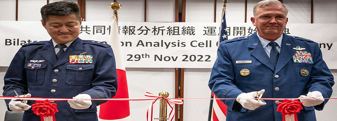 YOKOTA AIR BASE, TOKYO, Japan (Nov. 29, 2022) - Lt. Gen. SUZUKI Yasuhiko, vice chief of staff, Japan Joint Staff and Lt. Gen. Ricky Rupp, commander, U.S. Forces Japan, perform a ceremonial ribbon cutting during the U.S.-Japan Bilateral Intelligence Analysis Cell (BIAC) opening ceremony at the USFJ headquarters on Yokota Air Base, Japan, Nov. 29, 2022. The U.S.-Japan BIAC functions to jointly analyze and process information gathered from assets of both countries in support of mutual security and cooperation.