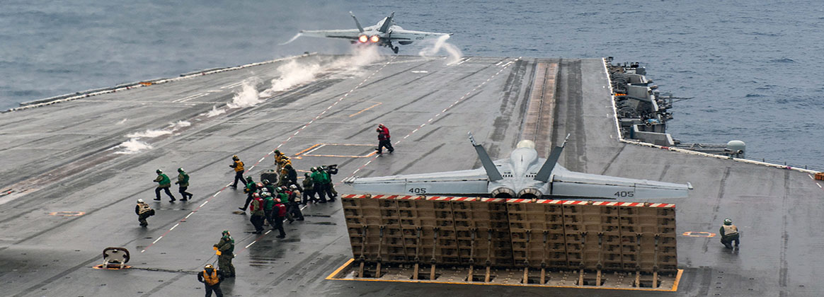 PHILIPPINE SEA (May 31, 2023) - An F/A-18E Super Hornet, attached to the Royal Maces of Strike Fighter Squadron (VFA) 27, launches as an F/A-18E Super Hornet, attached to the Dambusters of Strike Fighter Squadron (VFA) 195, prepares to launch on the flight deck of the U.S. Navy’s only forward-deployed aircraft carrier, USS Ronald Reagan (CVN 76), in the Philippine Sea, May 31, 2023. The Royal Maces conduct carrier-based air strikes and strike force escort missions, as well as ship, battle group, and intelligence collection operations. Ronald Reagan, the flagship of Carrier Strike Group 5, provides a combat-ready force that protects and defends the United States, and supports alliances, partnerships and collective maritime interests in the Indo-Pacific region. 