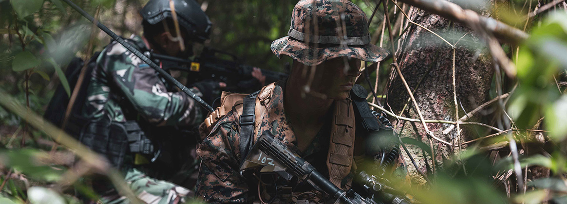 231203-M-HA226-1027 SUKABUMI, Indonesia (Dec. 3, 2023) U.S. Marine Corps Cpl. Jasper McCoubrey, a radio operator, with 1st Battalion, 7th Marine Regiment, attached to Marine Rotational Force-Southeast Asia, I Marine Expeditionary Force, and an Indonesian marine with 4th Marine Infantry Brigade, Pasmar 1, hold security while conducting a patrol during Keris Marine Exercise 2023 at Piabung Training Area in Sukabumi, West Java, Indonesia, Dec. 3, 2023. Keris MAREX is a bilateral exercise led by the U.S. Marine Corps and the Indonesian Marine Corps, or Korps Marinir, to promote military interoperability and maritime domain awareness capabilities, strengthen relationships, and expand military capabilities among participating forces in the advancement of a Free and Open Indo-Pacific. (U.S. Marine Corps photo by Cpl. Dean Gurule)