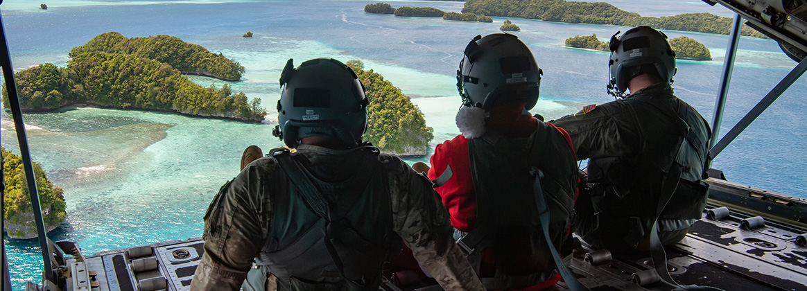 231203-O-PM645-2364 PALAU (Dec. 3, 2023) (Left to right) U.S. Air Force Master Sgt. Michael Demik, Maj. Zach “Badger” Overbey, and Tech. Sgt. James Hurst, 36th Expeditionary Airlift Squadron Airmen, sit on the ramp of a C-130J Super Hercules after completing low-cost, low-altitude (LCLA) bundle drops at the island of Koror, Dec. 3, 2023 during Operation Christmas Drop 2023 (OCS 23). The capabilities employed during OCD are a unique method of delivery suited to the region. Coast Humanitarian Air Drop (CHAD) takes the LCLA capability to the types of environments seen in many places throughout the Pacific. (U.S. Air Force photo by Yasuo Osakabe)