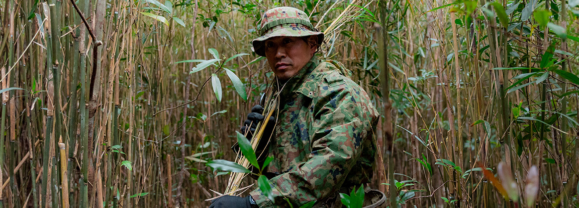 240225-M-WE079-1172 OKINAWA, Japan (Feb. 25, 2024) A soldier with the Amphibious Rapid Deployment Brigade Recon Company, Japan Ground Self-Defense Force gathers jungle brush for a shelter during jungle field training for Iron Fist 24, at Jungle Warfare Training Center, Camp Gonsalves, Okinawa, Japan, Feb. 25, 2024. Bilateral training tests readiness and ability to respond to crisis in challenging and time-sensitive conditions. Iron Fist is an annual bilateral exercise designed to increase interoperability and strengthen the relationships between the U.S. Marine Corps, the U.S. Navy, the JGSDF, and the Japanese Maritime Self-Defense Force. (U.S. Marine Corps photo by Cpl. Tyler Andrews)