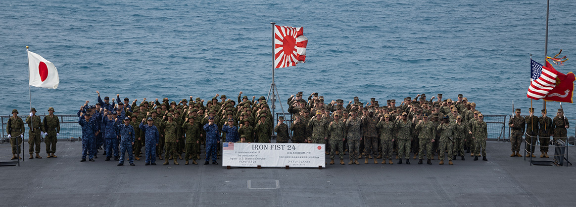 240317-M-QS704-1142 JS KUNISAKI, OKINAWA, Japan (March 17, 2024) U.S Marines with the 31st Marine Expeditionary Unit, U.S. Navy Sailors with the America Amphibious Ready Group, Japanese Ground Self-Defense Force Soldiers, and Japan Maritime Self-Defense Force sailors pose for a group photo following the Iron Fist 24 closing ceremony aboard the Osumi-class tank landing ship JS Kunisaki (LST-4003) in Okinawa, Japan, Mar. 17, 2024. The closing ceremony concluded training between the armed forces and awarded servicemembers for outstanding performance during Iron Fist 24. Iron Fist is an annual bilateral exercise designed to increase interoperability and strengthen the relationships between the U.S. Marine Corps, the U.S. Navy, the Japanese Ground Self-Defense Force, and the Japanese Maritime Self-Defense Force. (U.S. Marine Corps photo by Cpl. Juan K. Maldonado)